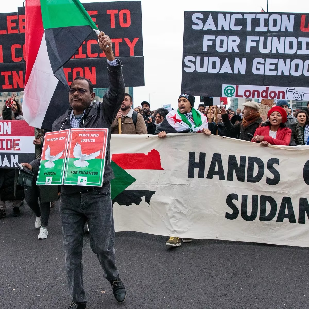 Sudanese activists demonstrating in a "Hands Off Sudan" protest in London last year. One sign reads "Sanction U.A.E. for Funding Sudan Genocide."