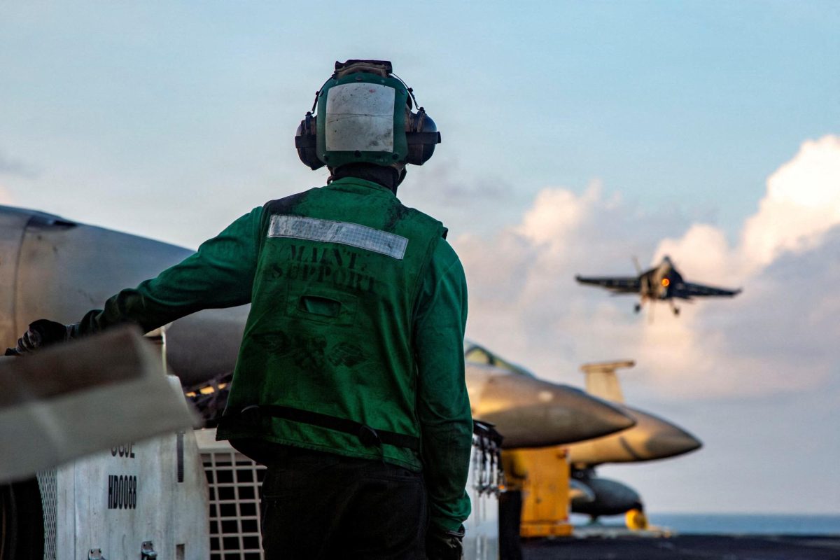A U.S. Sailor observes flight operations as an F/A-18E Super Hornet, attached to Strike Fighter Squadron 14, prepares to make an arrested landing on the flight deck of Nimitz-class aircraft carrier USS Abraham Lincoln supporting Operation Epic Fury during the Iran war at an undisclosed location, March 26, 2026. U.S. Navy/Handout via REUTERS
